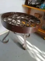 Unique wrought iron table featuring antique tools